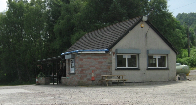 a single story building on a gravel car park, the cafe services at tarvie